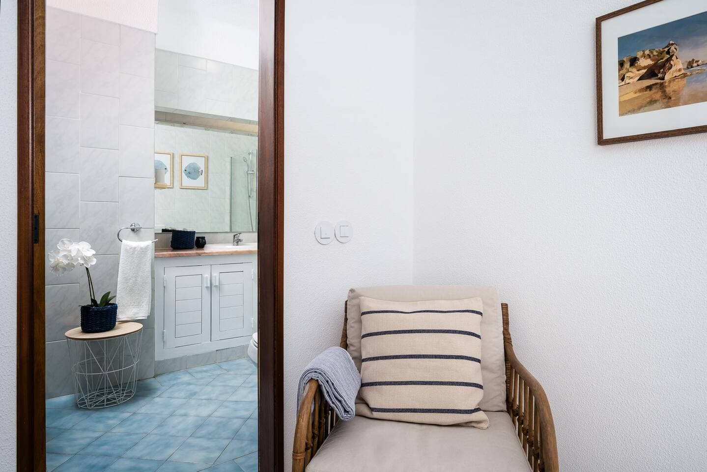 Corner of the en-suite bedroom on the 1st floor. Armchair with a view to the balcony. 