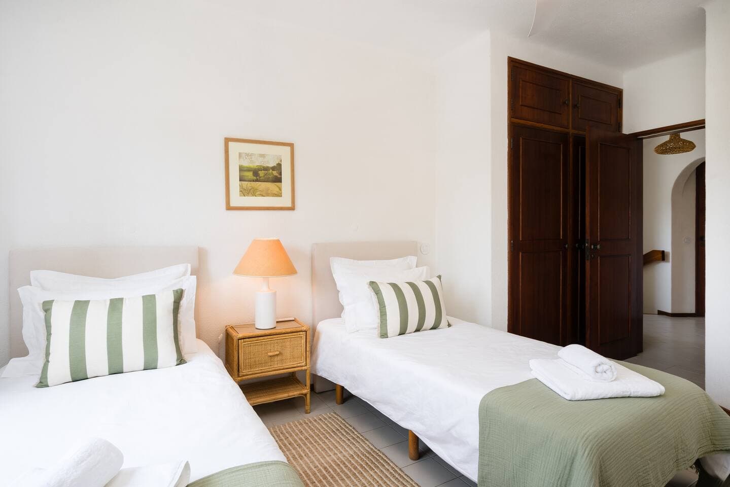 Second bedroom on the 1st floor with two single beds, wood wardrobe, flexible layout and plenty natural light. 