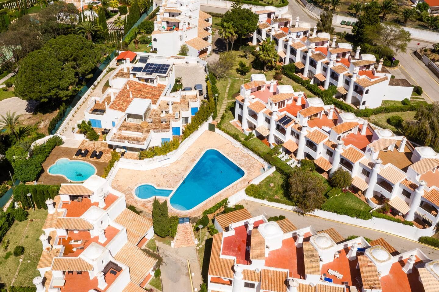 Pool area set among traditional Algarve villas.