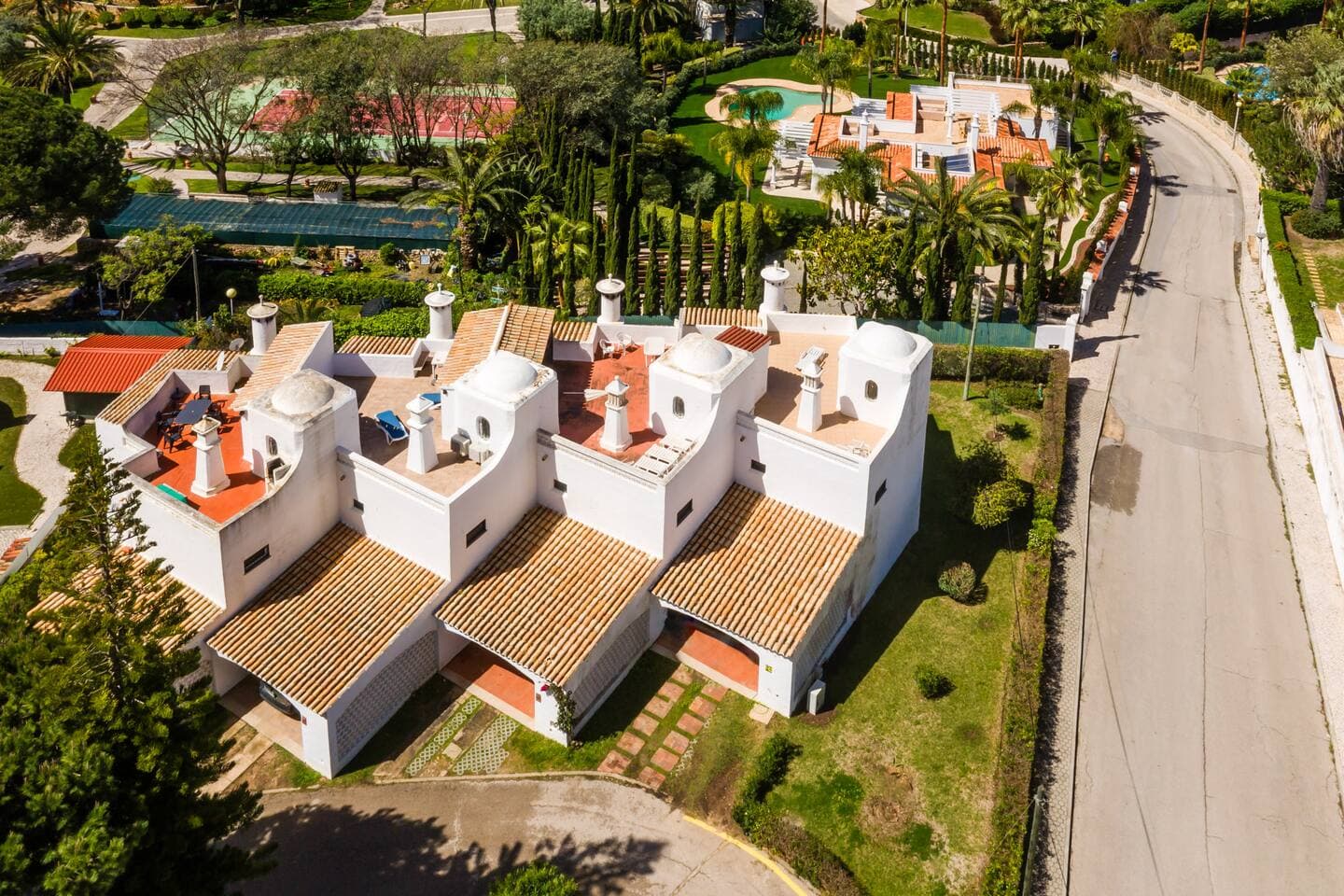 Traditional Algarve architecture surrounded by greenery.