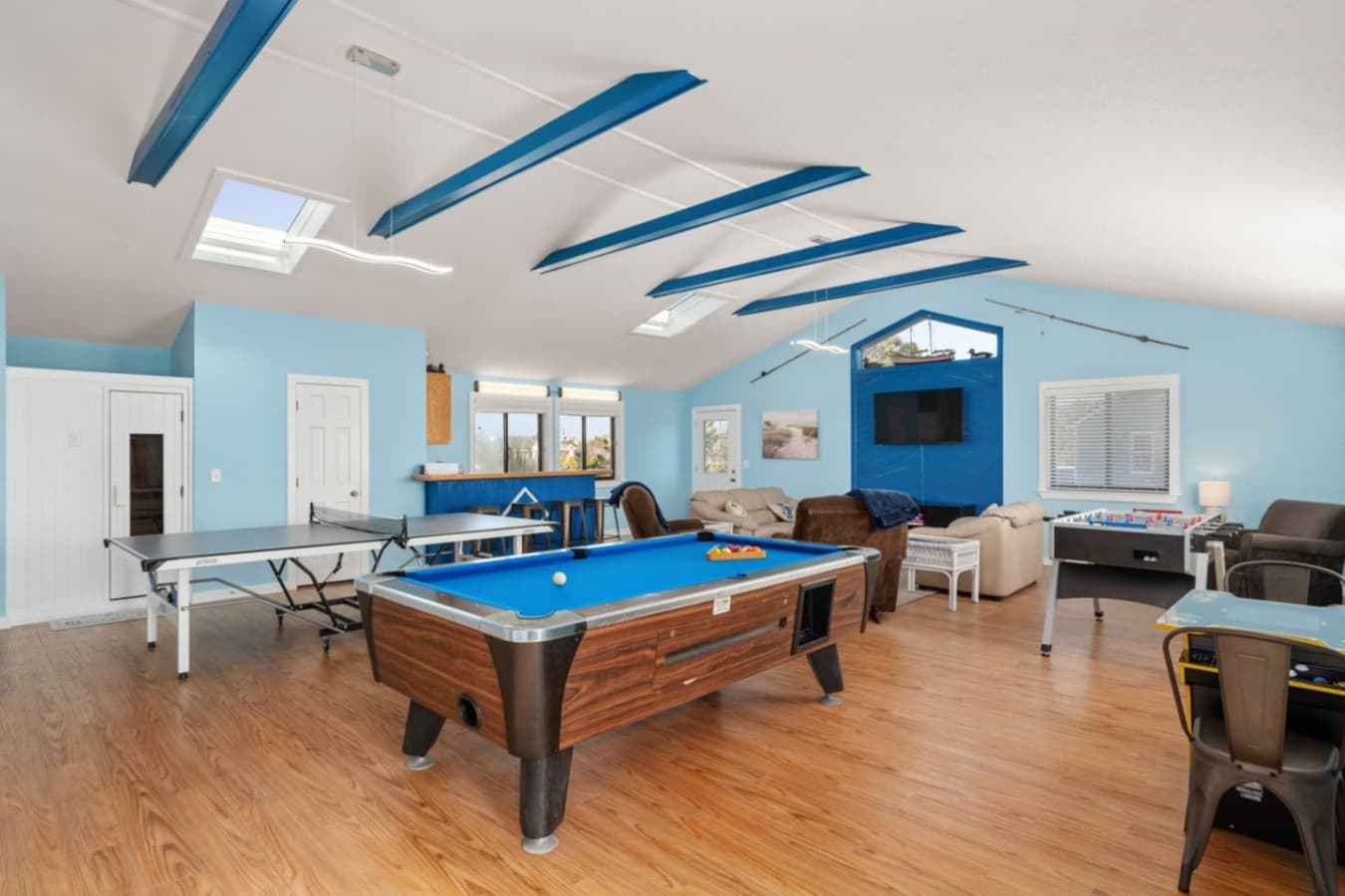 Game room setup w/ pool table & casual seating, ideal for friendly competition indoors.