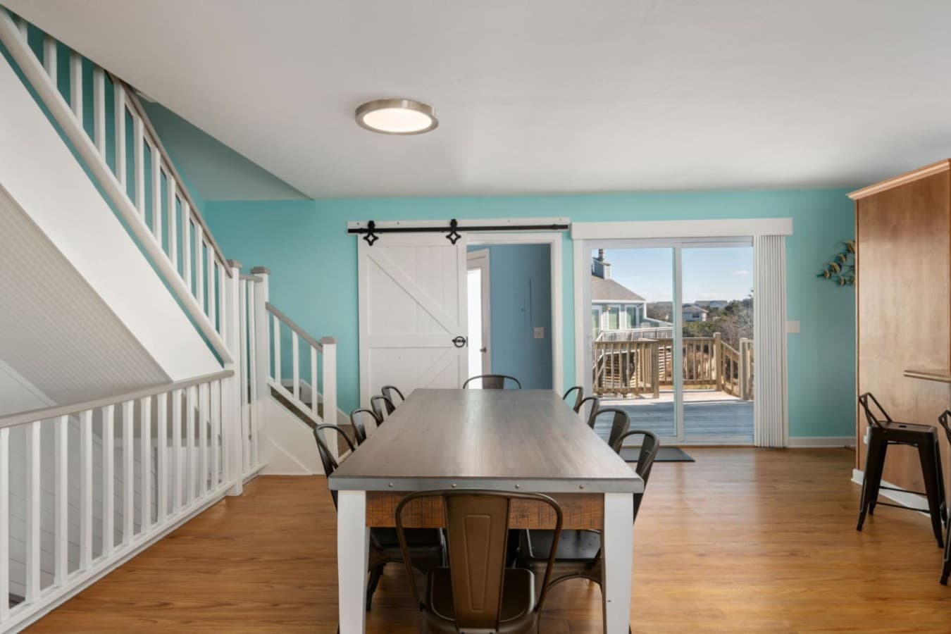 Open stairway & entry area w/ airy blue tones, creating a welcoming flow between levels.