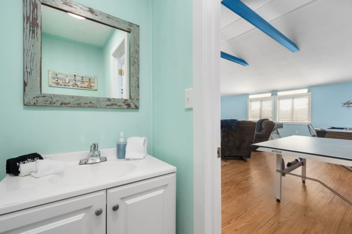 Bright bathroom vanity w/ double sinks, clean finishes, & coastal accents for easy mornings.