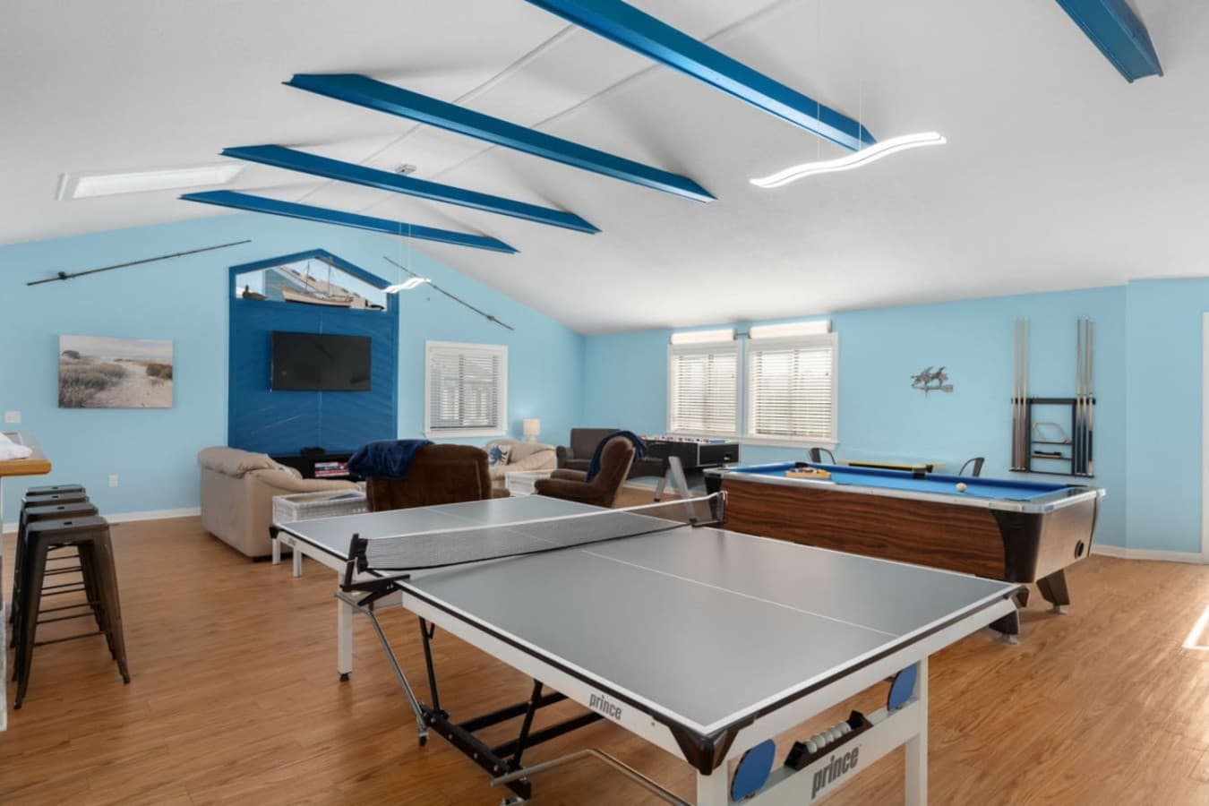 Game room w/ pool table, seating, & nautical ceiling accents for laid-back indoor fun