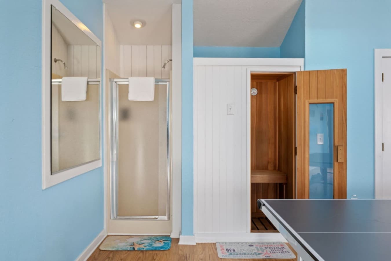 Clean bath area w/ walk-in shower & a cozy wood sauna tucked just off the room.