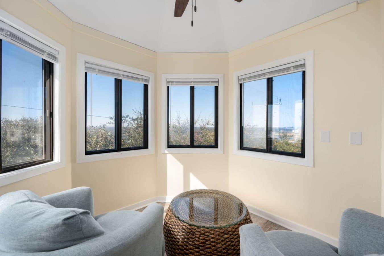 Cozy sitting area w/ corner windows offering peaceful views & a sunny place to unwind.