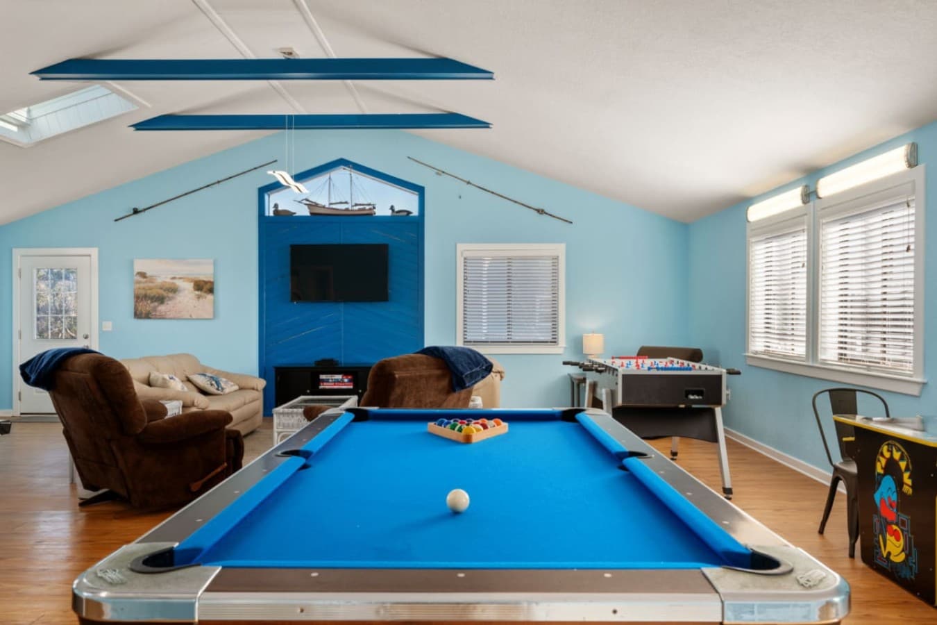 Game room w/ pool table & seating, set up for friendly competition & downtime.