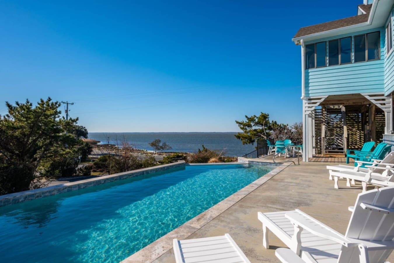 Infinity pool w/ wide sound views, ideal for sunny swims & long afternoons on the loungers.