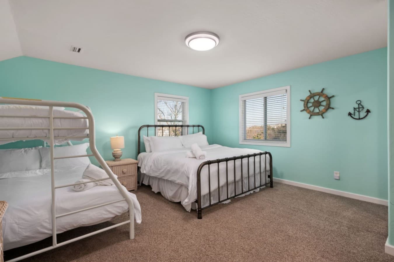 Spacious bedroom w/ twin beds & coastal decor, great for kids or friends.