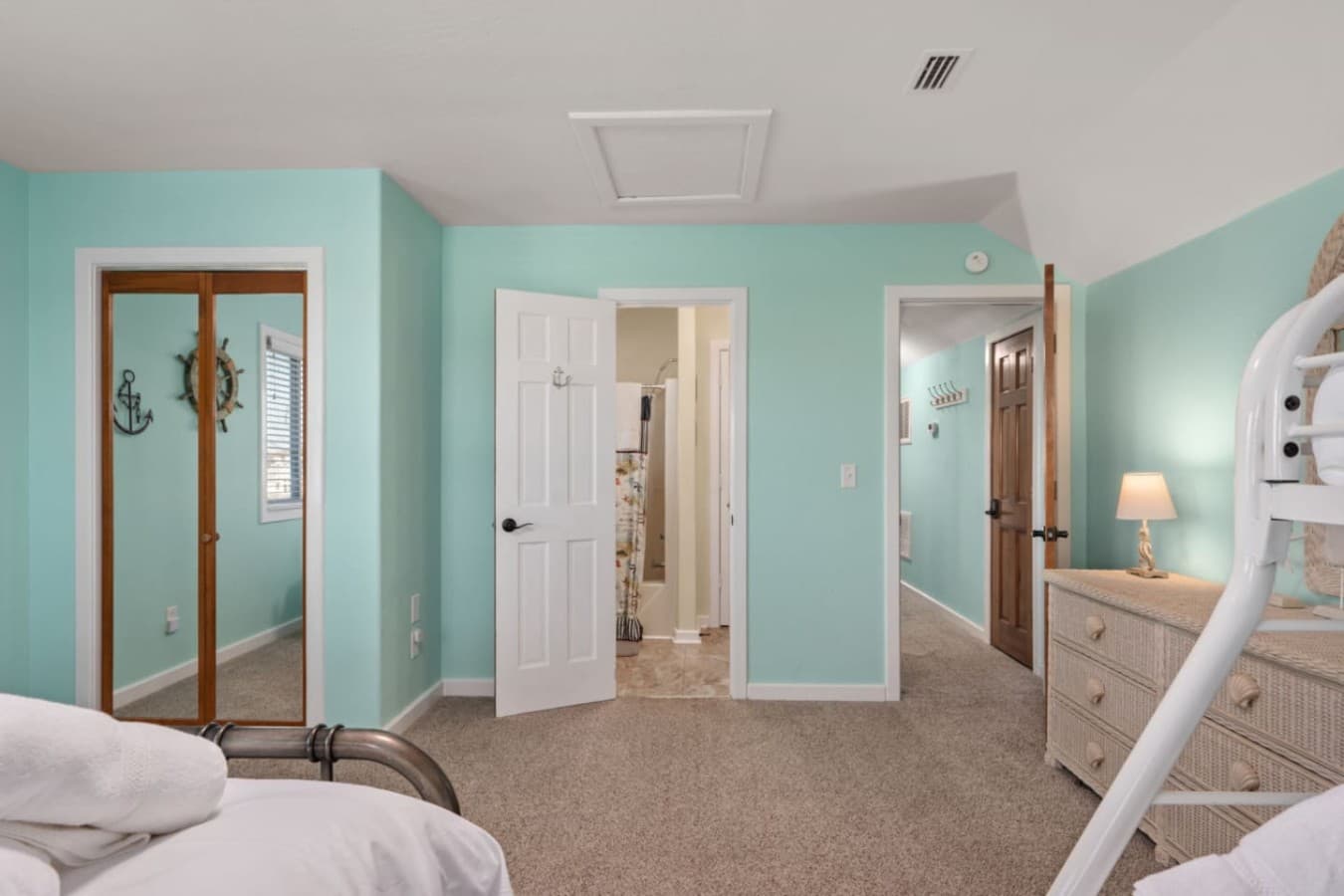 Bright hallway w/ soft coastal colors, connecting bedrooms & baths with an open, airy feel.