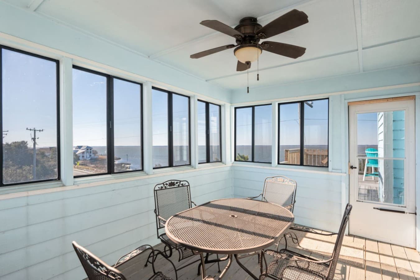 Sunlit living space wrapped in windows, offering a relaxed spot to gather & unwind.