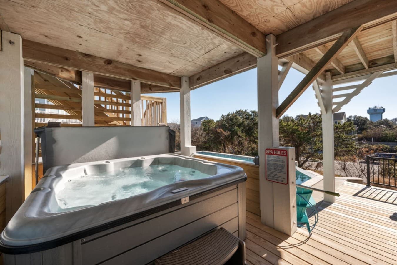 Covered hot tub on the deck w/ a lattice screen & open views over the scrub.