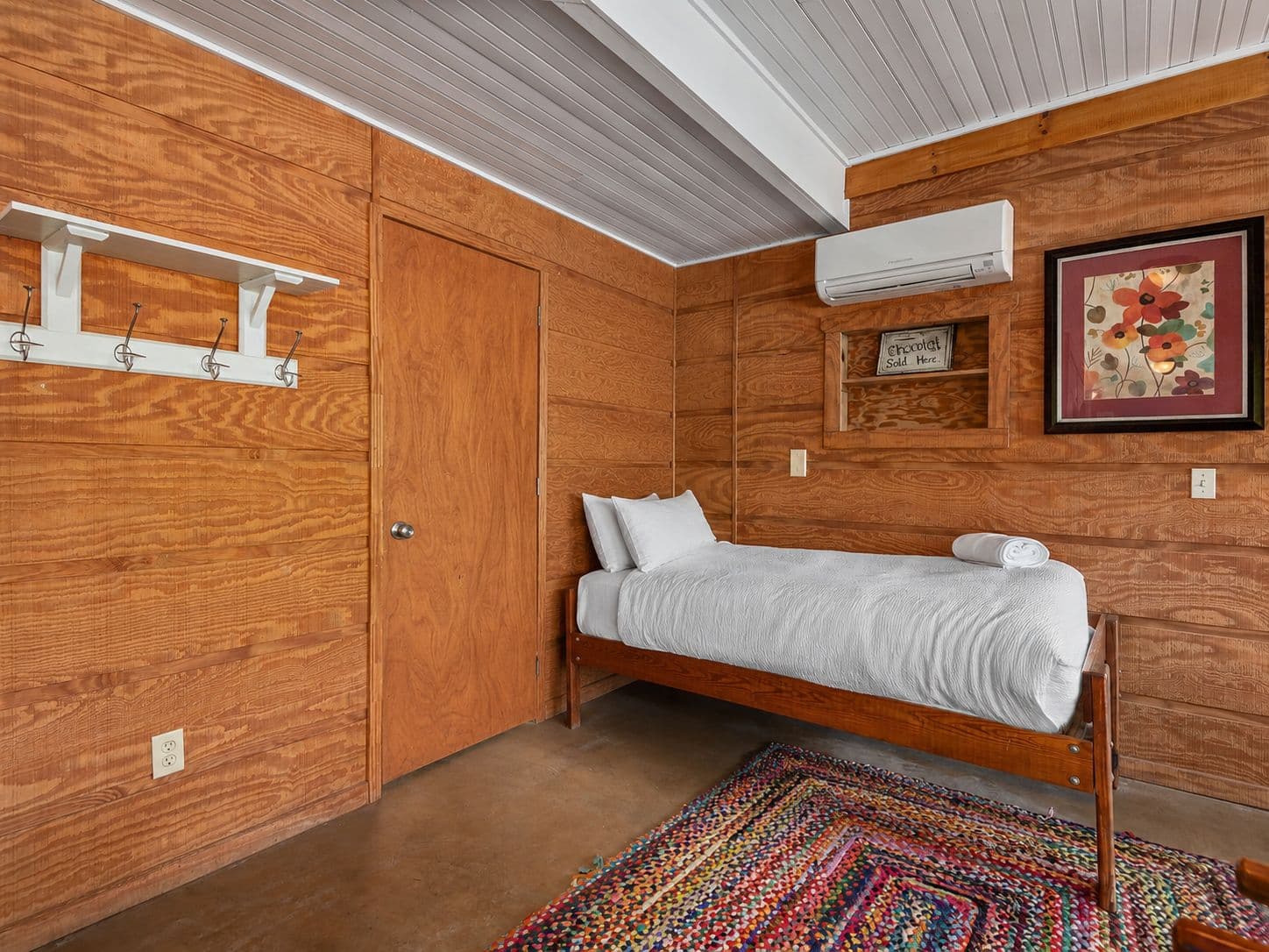 The other twin bed in the lower living room, next to the laundry.