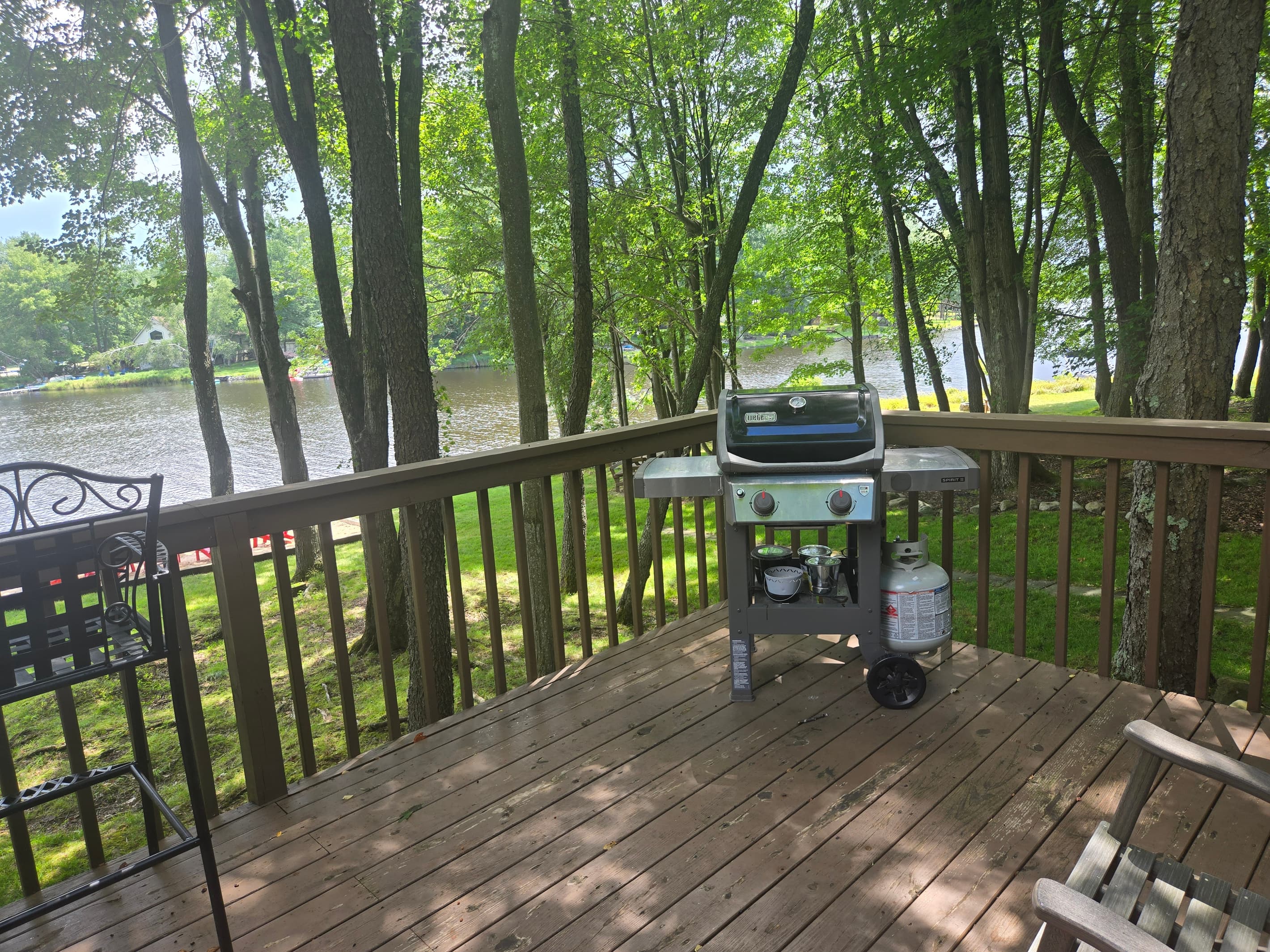 Deck with seating/table and BBQ grill, overlooking the lake
