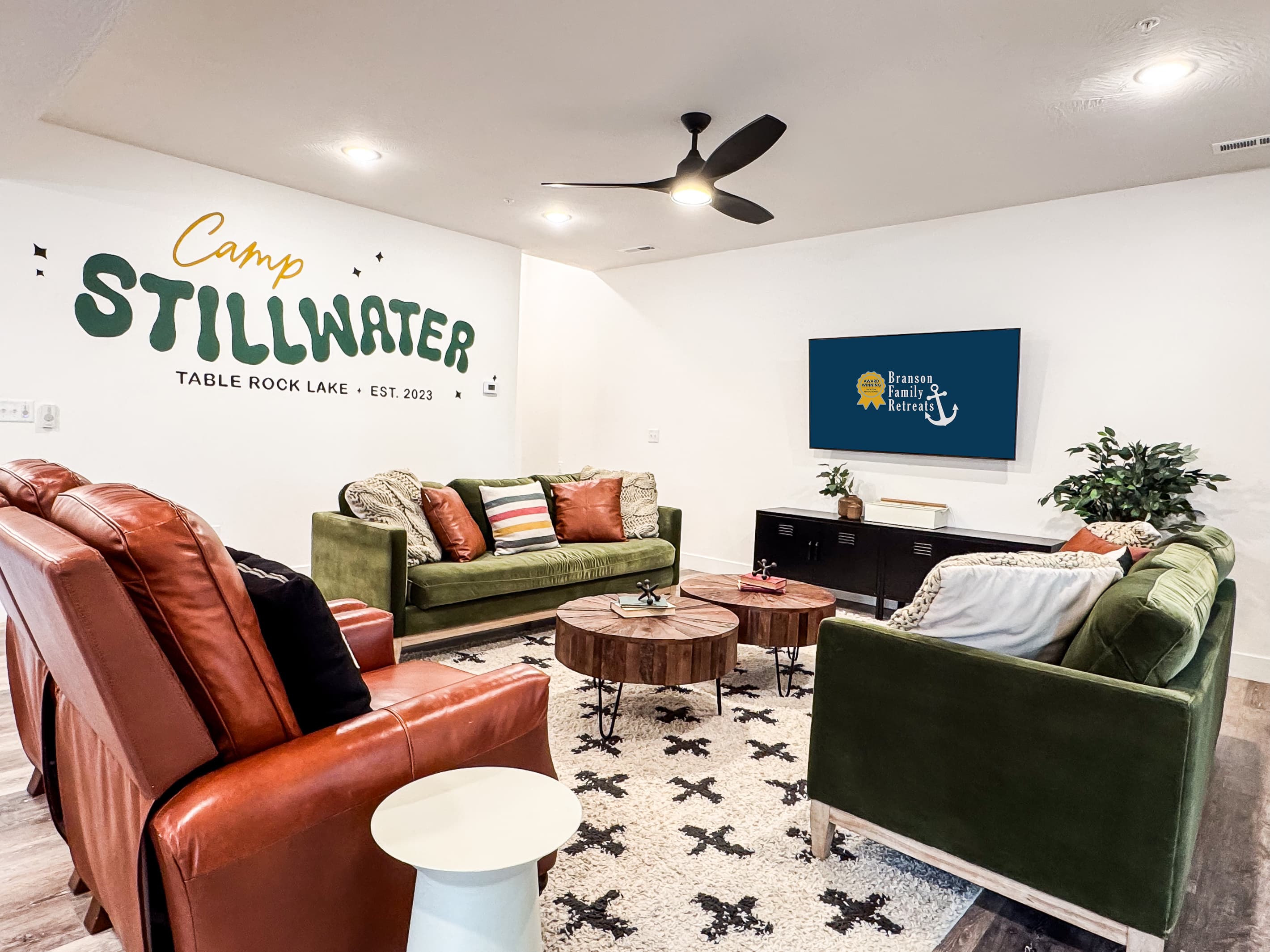 Living room featuring Tv with 2 couches and 2 leather seats