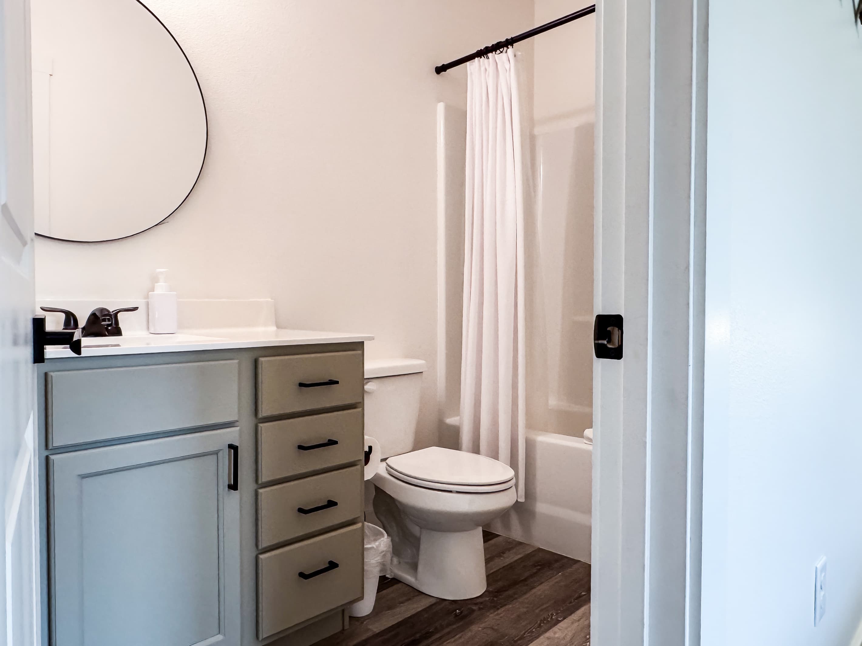 Bedroom 2 En-suite bathroom with a tub shower, toilet, and vanity