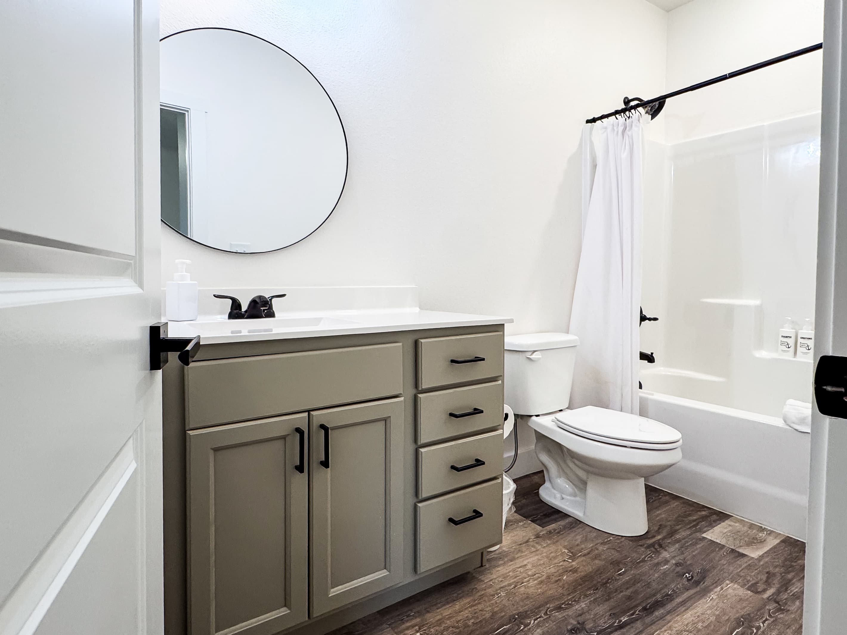 Bedroom 2 En-suite bathroom with a tub shower, toilet, and vanity