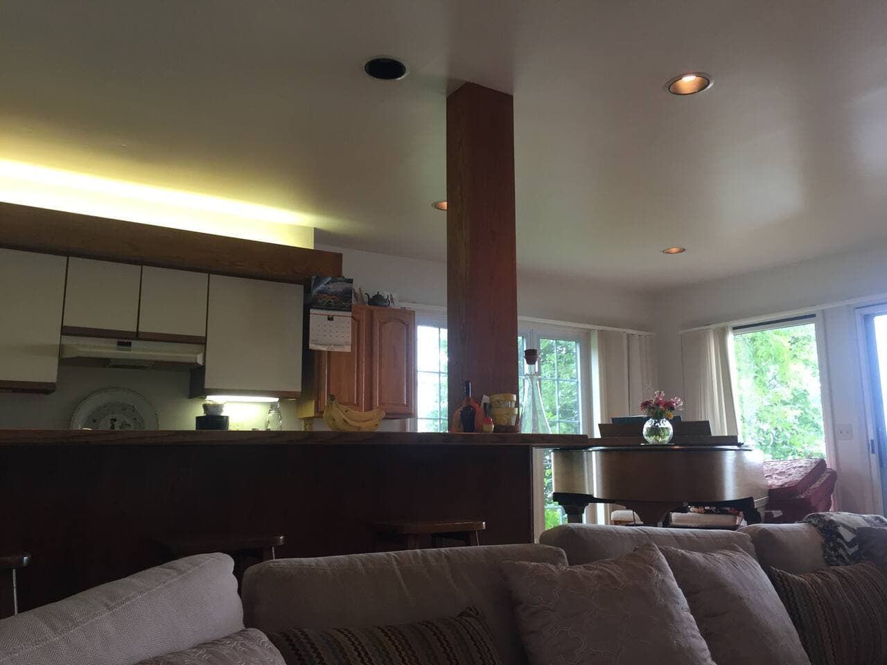 Breakfast bar and kitchen open up to lake bing and dining room area 