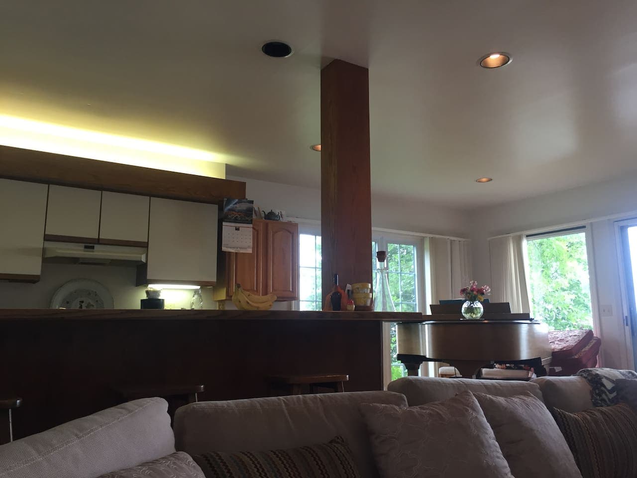 Breakfast bar and kitchen open up to lake bing and dining room area 