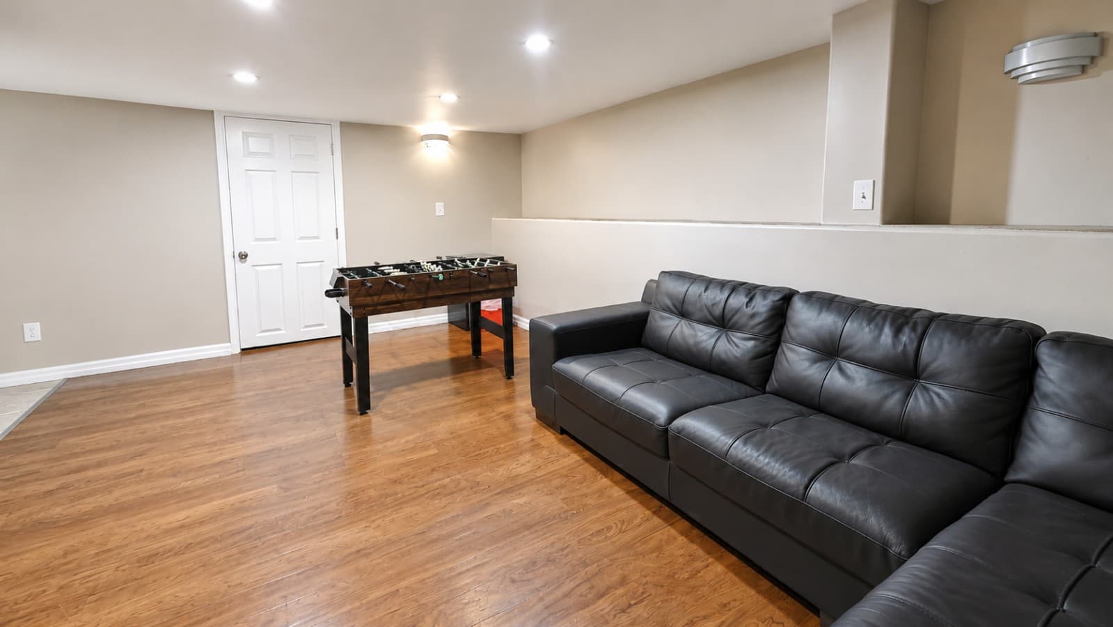 Stretch out on the spacious sectional, enjoy a movie, or challenge your group to a friendly foosball match..png