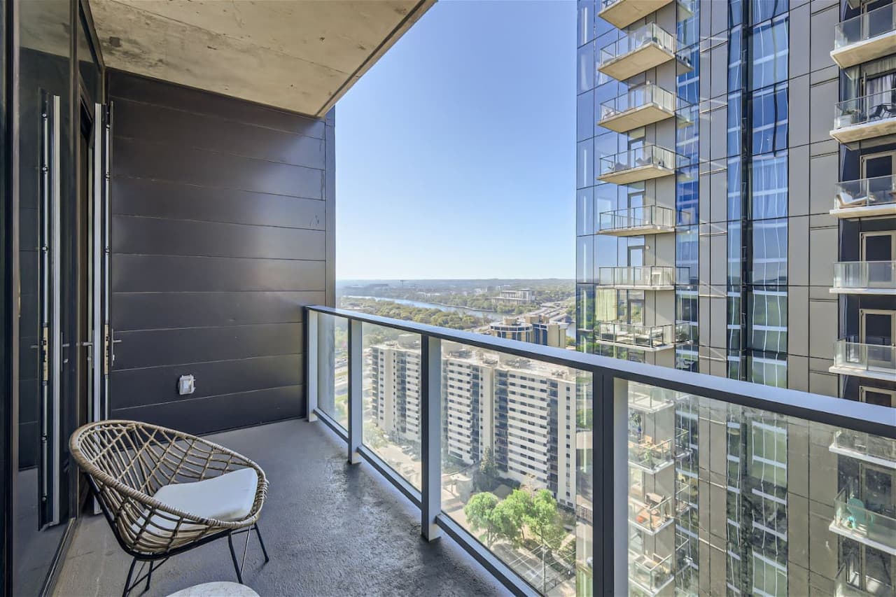 The balcony, exquisitely designed with a touch of luxury, captures breathtaking views of both the serene lake and the bustling city, offering a picturesque setting to relax and admire the best of both worlds.