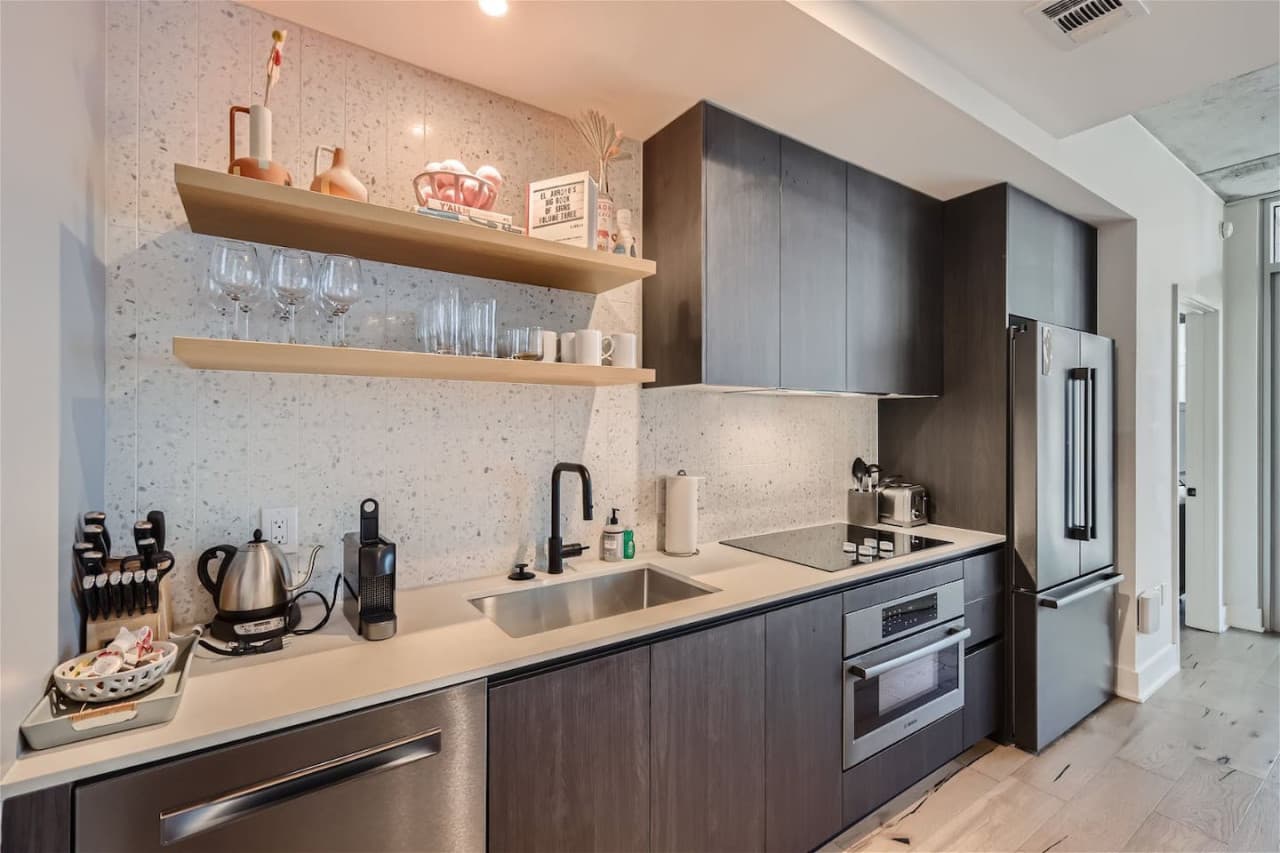 A luxurious kitchen featuring top-of-the-line appliances including a Nespresso coffee maker.