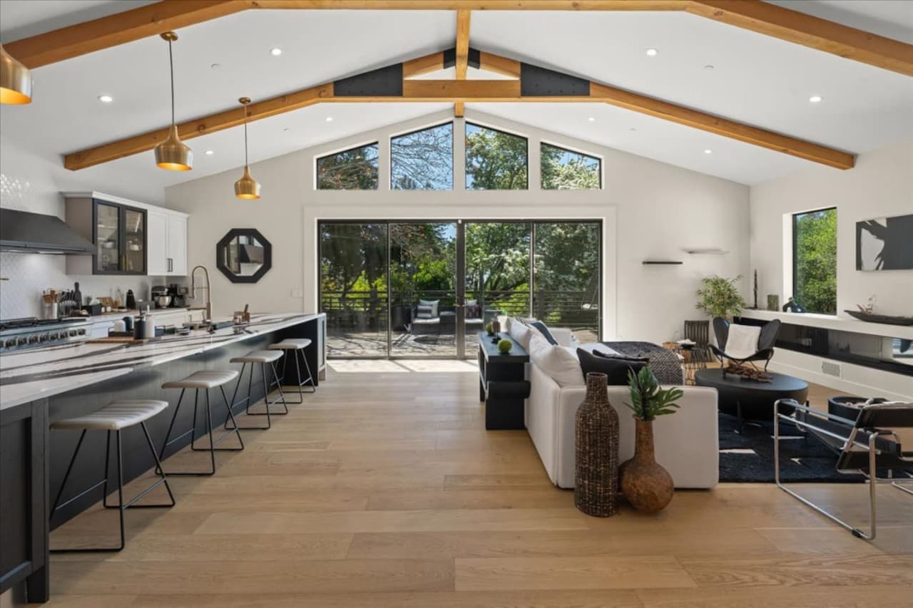 Discover the open layout featuring vaulted ceilings, exposed architectural beams and high end finishes.
