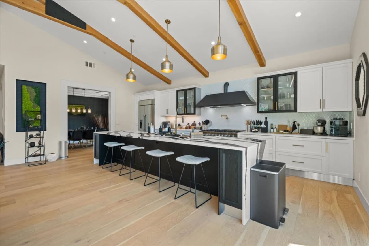 Discover the open layout featuring vaulted ceilings, exposed architectural beams and high end finishes.