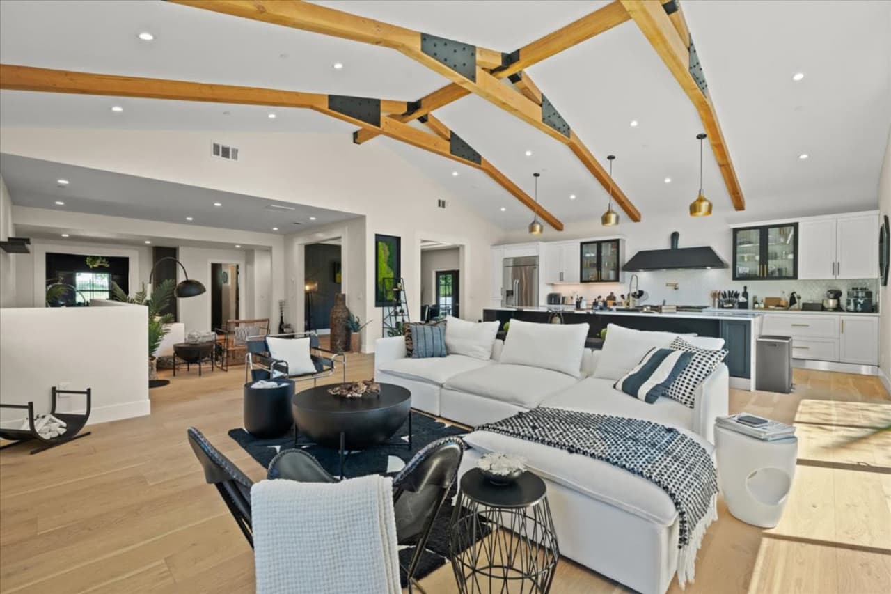 Discover the open layout featuring vaulted ceilings, exposed architectural beams and high end finishes.