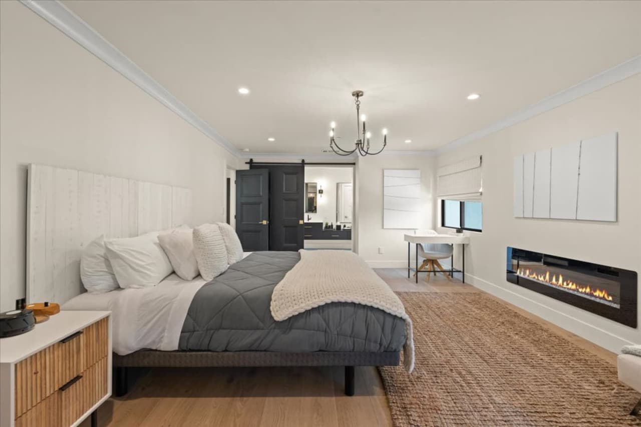 The primary suite is the perfect place to retreat to,  featuring an en-suite bathroom, custom built closet and a work station along with a fireplace.
