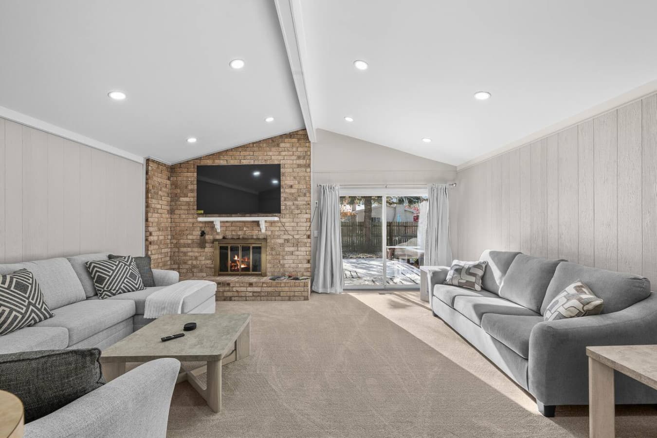 A bright living room with a cozy fireplace and plenty of natural light.