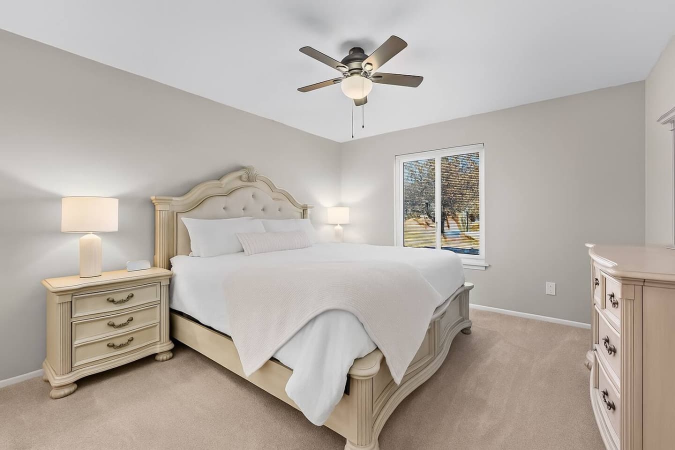 A bright bedroom with a comfortable king bed and soft neutral tones.