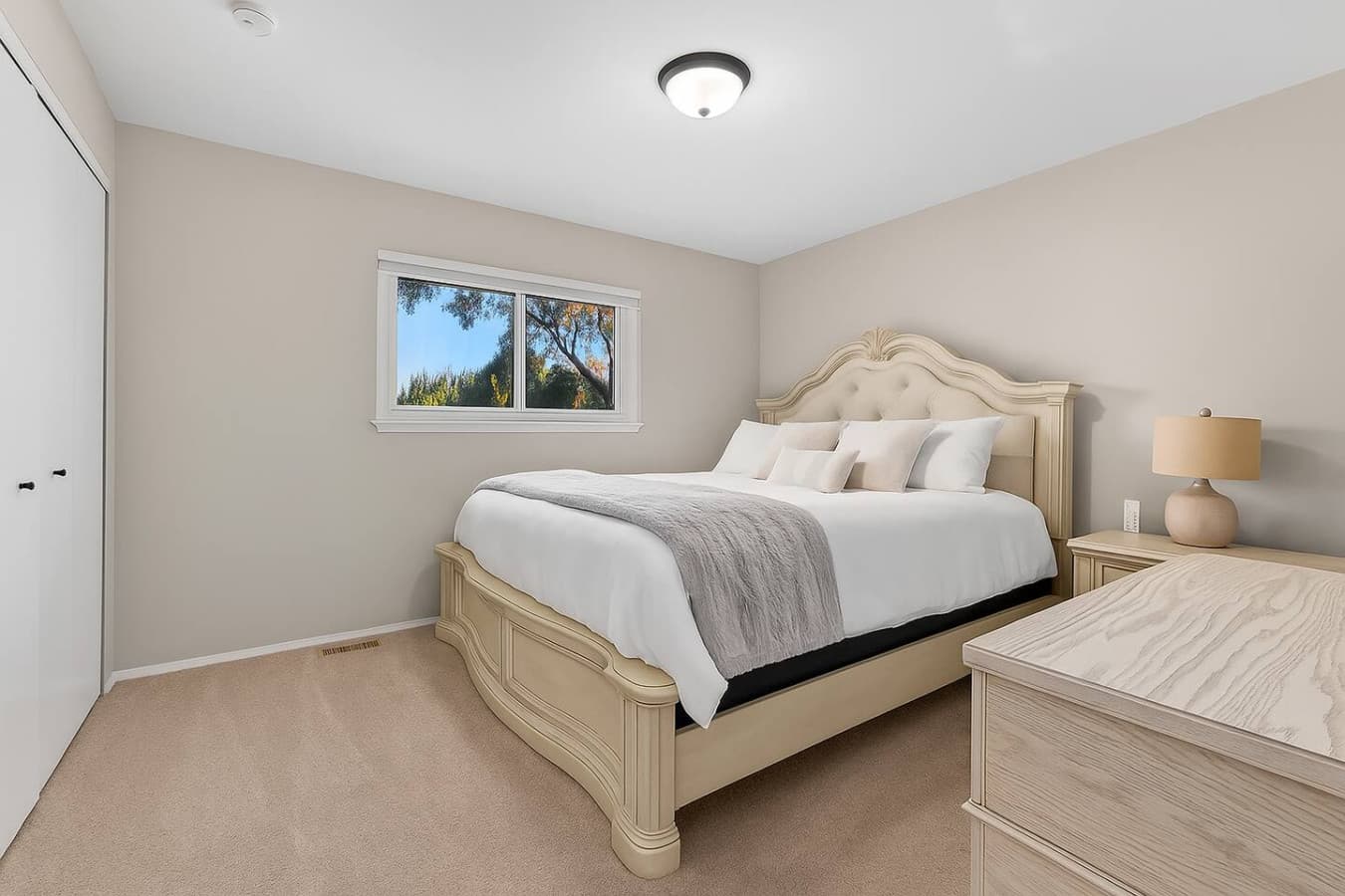 A bright and inviting room with relaxing views and cozy bedding.