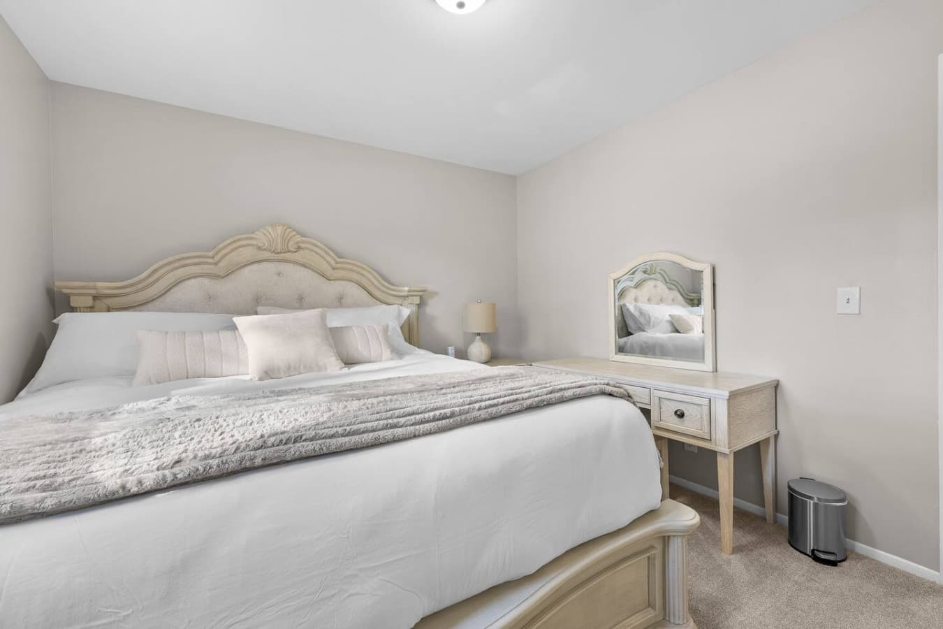 A warm bedroom with a comfortable bed and soft neutral decor.