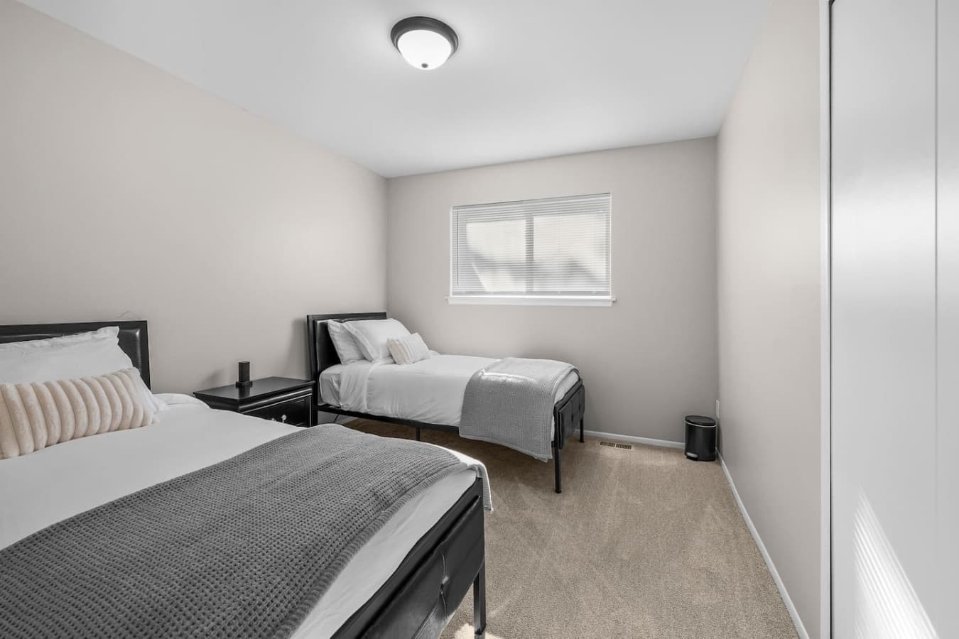 A clean and bright bedroom with two comfortable twin beds.