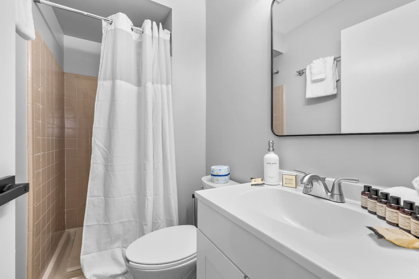 A clean and modern bathroom with a fresh shower and bright vanity area.