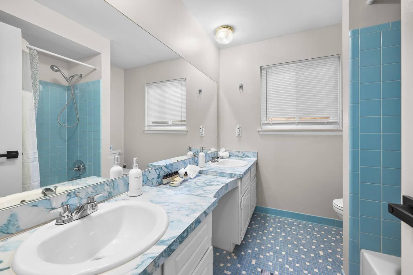 A spacious bathroom with a wide vanity and plenty of counter space.