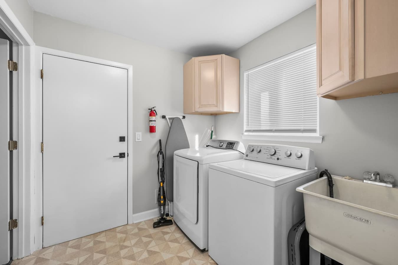 A bright utility space with easy access to cleaning essentials.