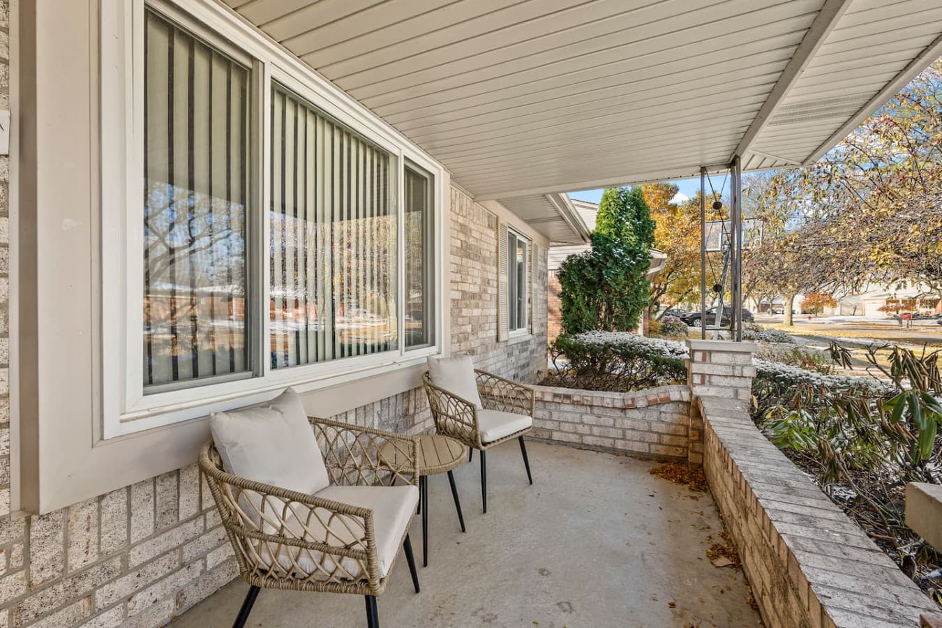 A cozy front porch with comfortable seating for relaxing outdoors.