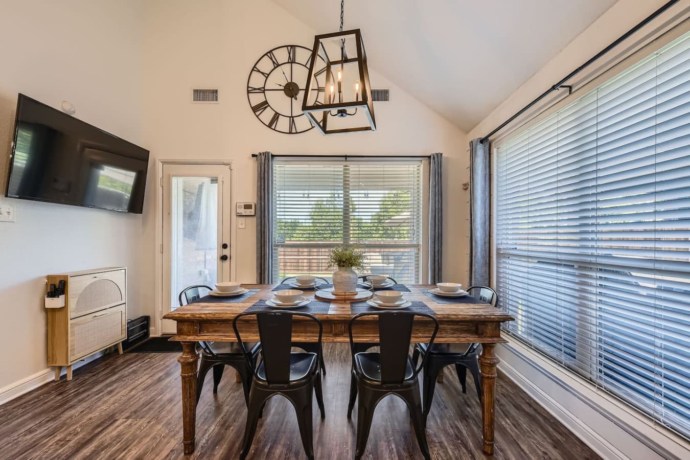 Enjoy meals in the dining area, complete with its own TV, a farmhouse table, and seating for six.