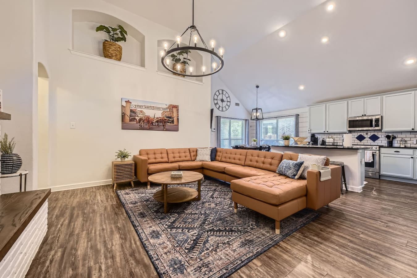 Relax on the sleek leather sectional and enjoy cozy evenings by the inviting glow of the electric fireplace.