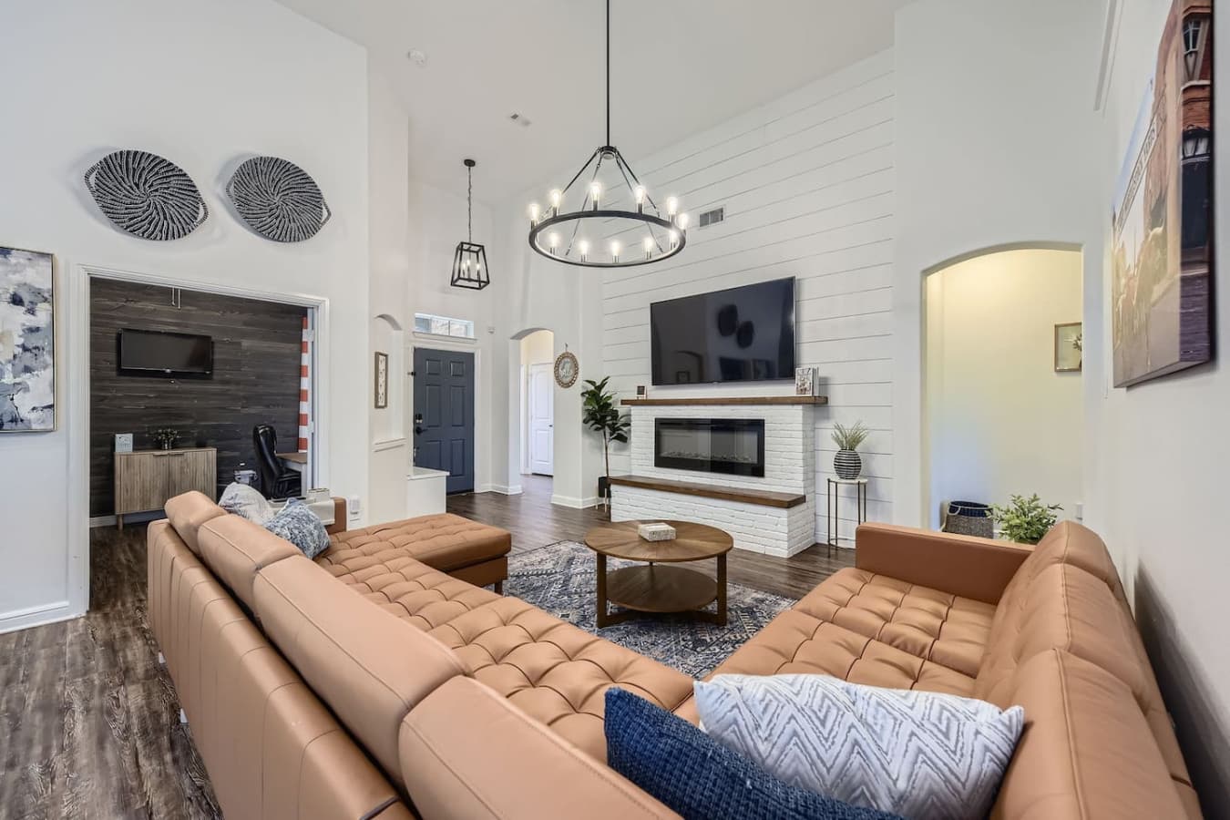 The sleek leather sectional and electric fireplace create the perfect spot for unwinding on cozy evenings.