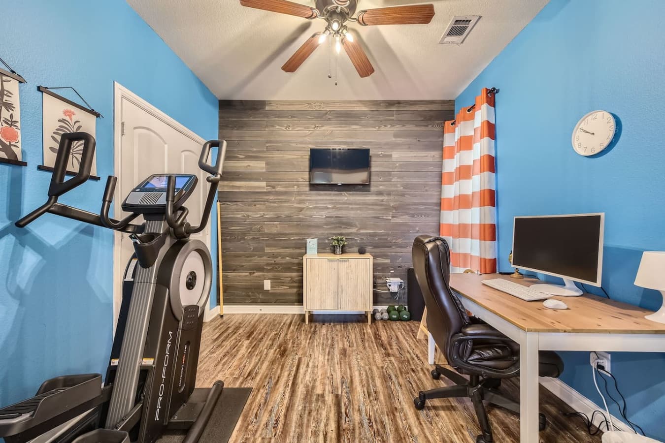 You'll find a dedicated office space off the living room, featuring a desk, elliptical machine, and Apple TV, making it great for remote work or exercise.