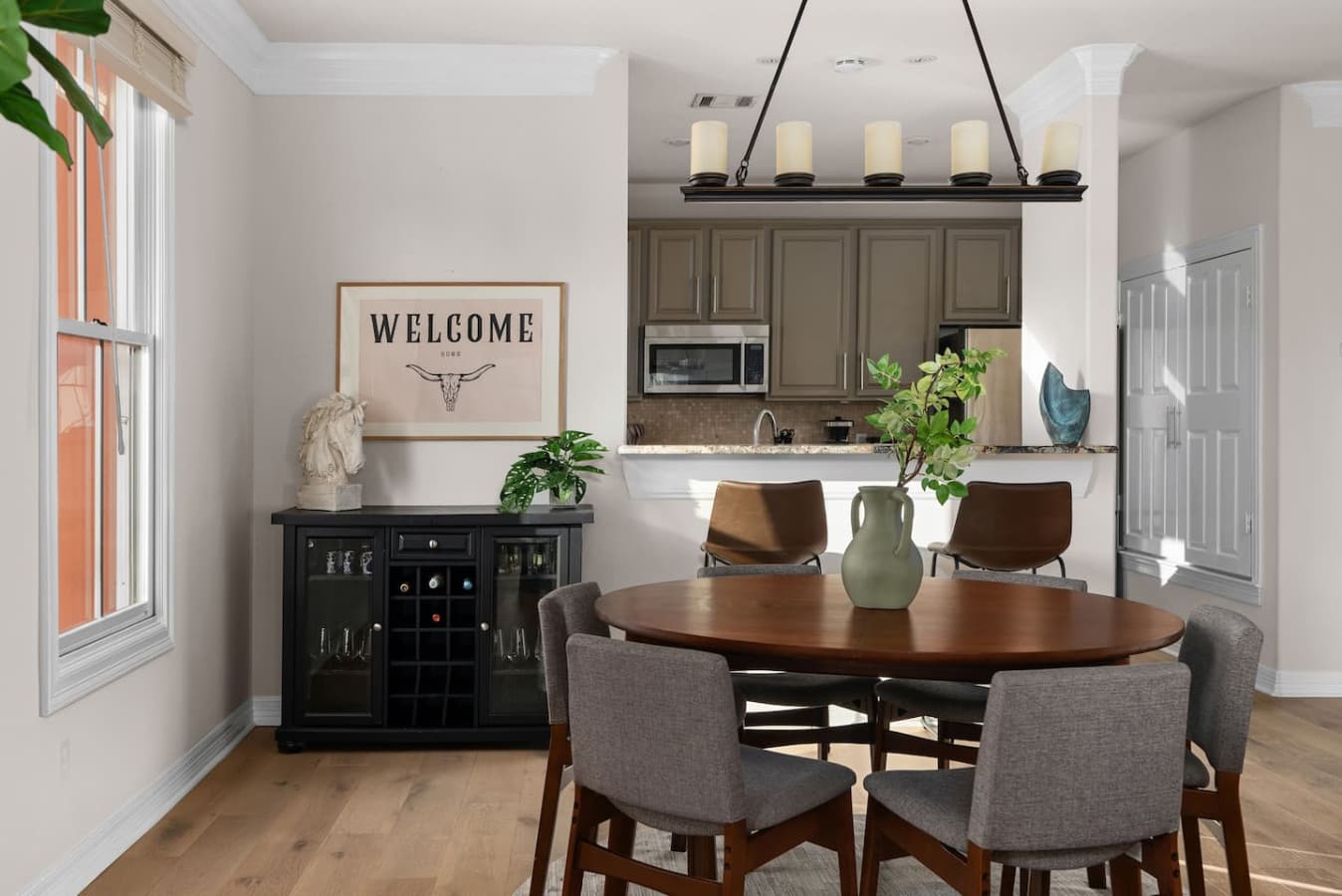 The sleek, modern kitchen is a chef's dream, equipped with top-of-the-line appliances and stylish cabinetry. The dining area, with its extendable table, seamlessly blends form and function, perfect for intimate dinners or larger gatherings.