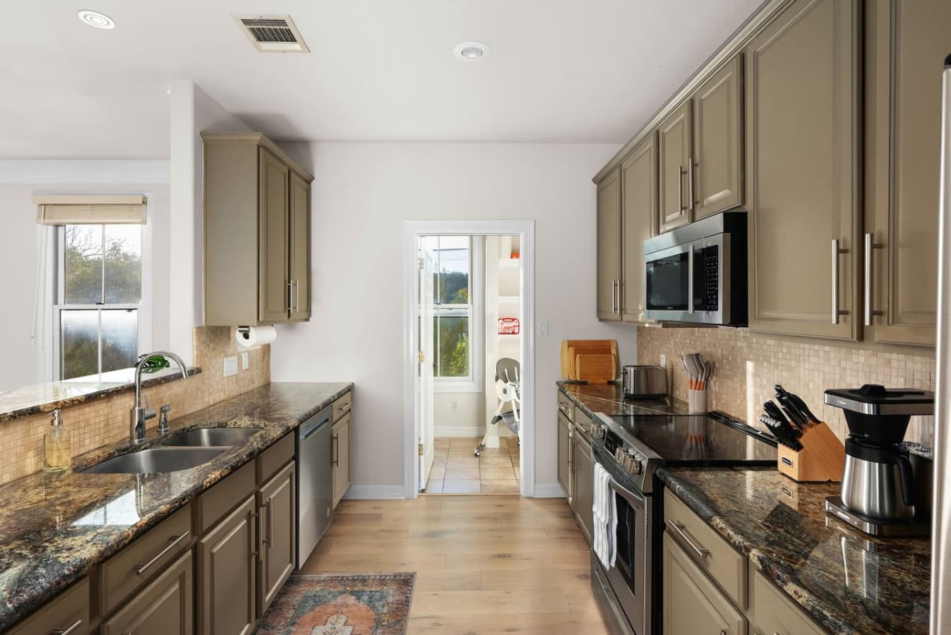 The sophisticated modern kitchen is a chef's dream, equipped with top-of-the-line appliances and a drip coffee maker for your morning brew.