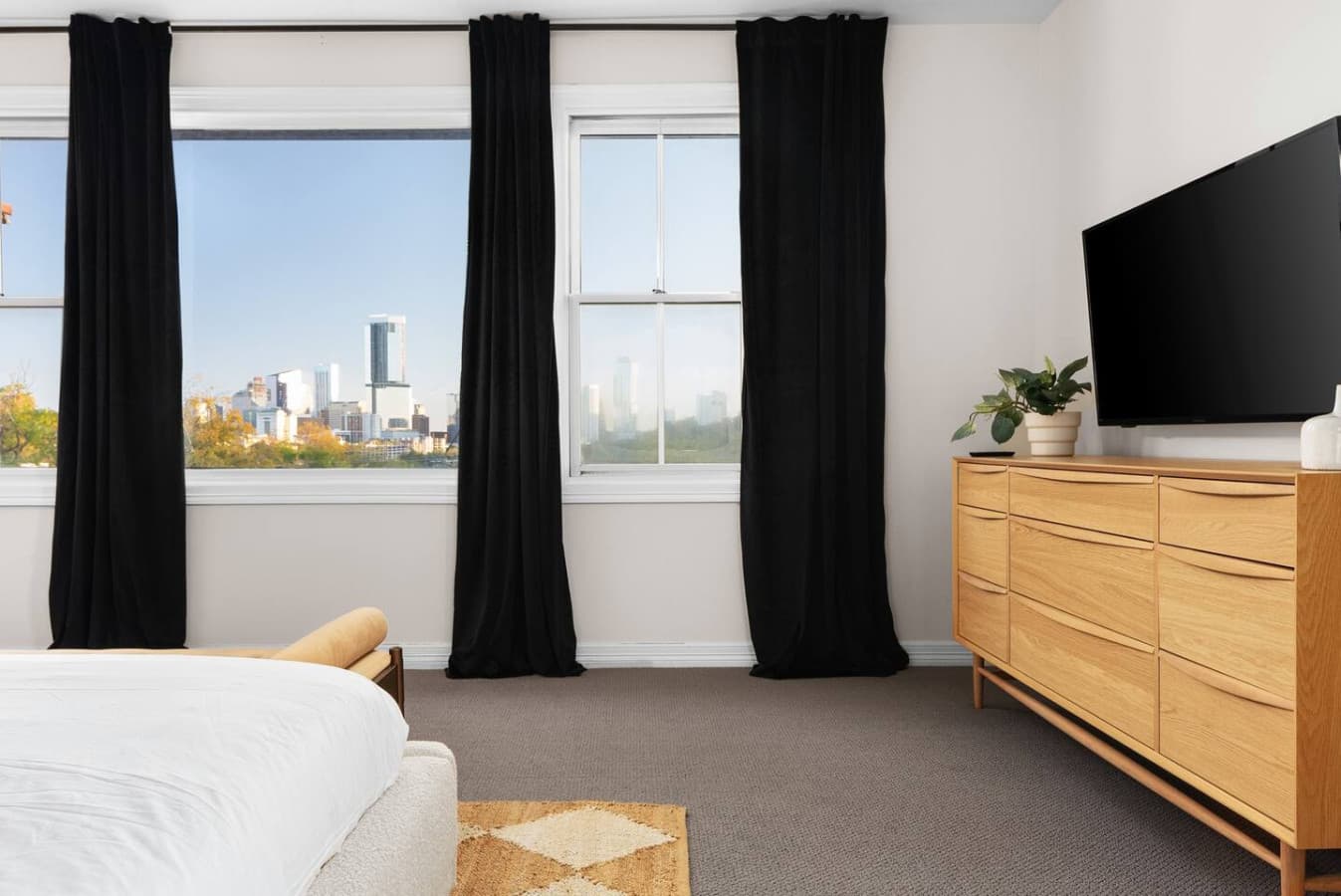 Stunning skyline views and a smart TV along with a king size bed are featured in the master bedroom.