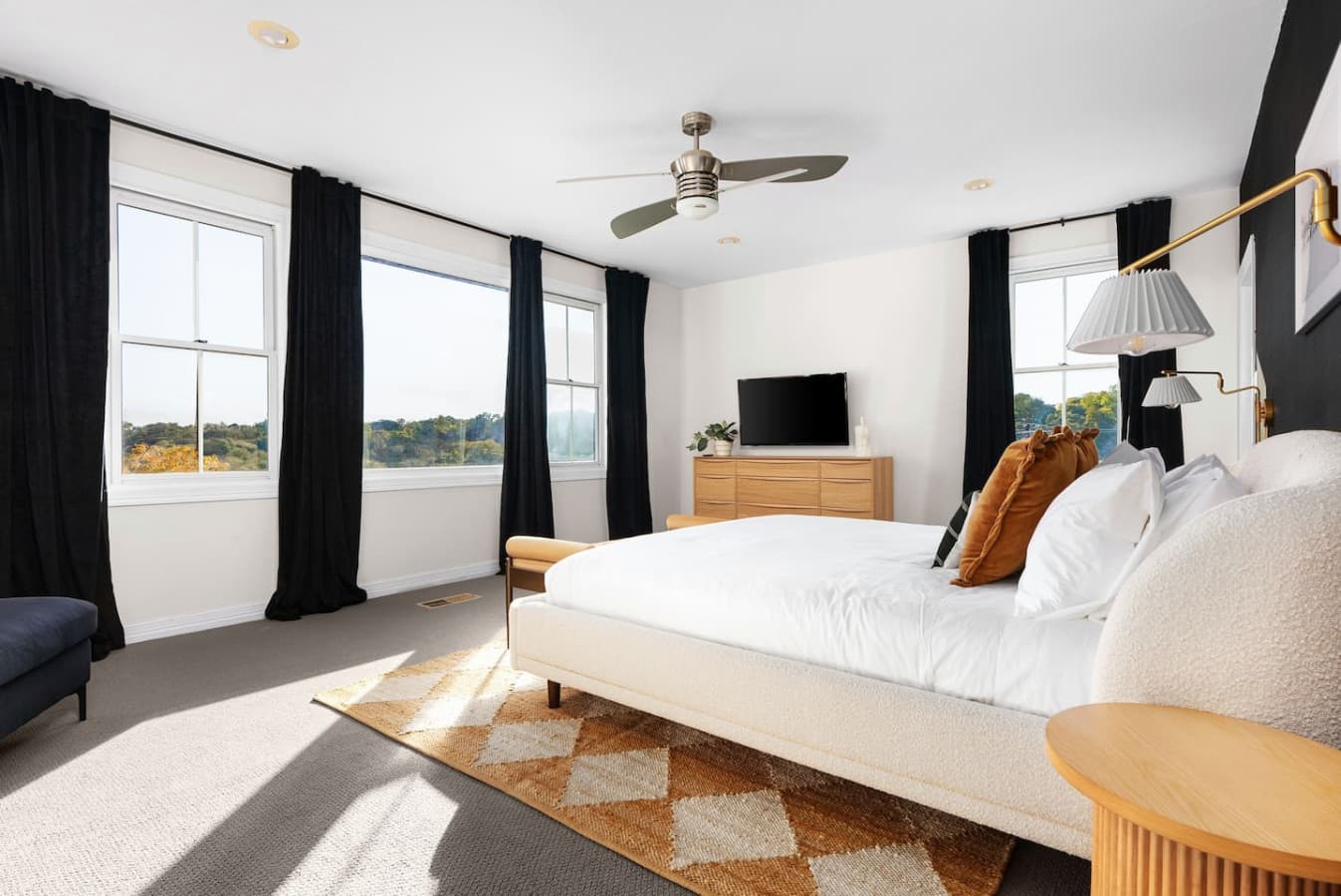 Master bedroom featuring a king size bed, smart TV and skyline views.