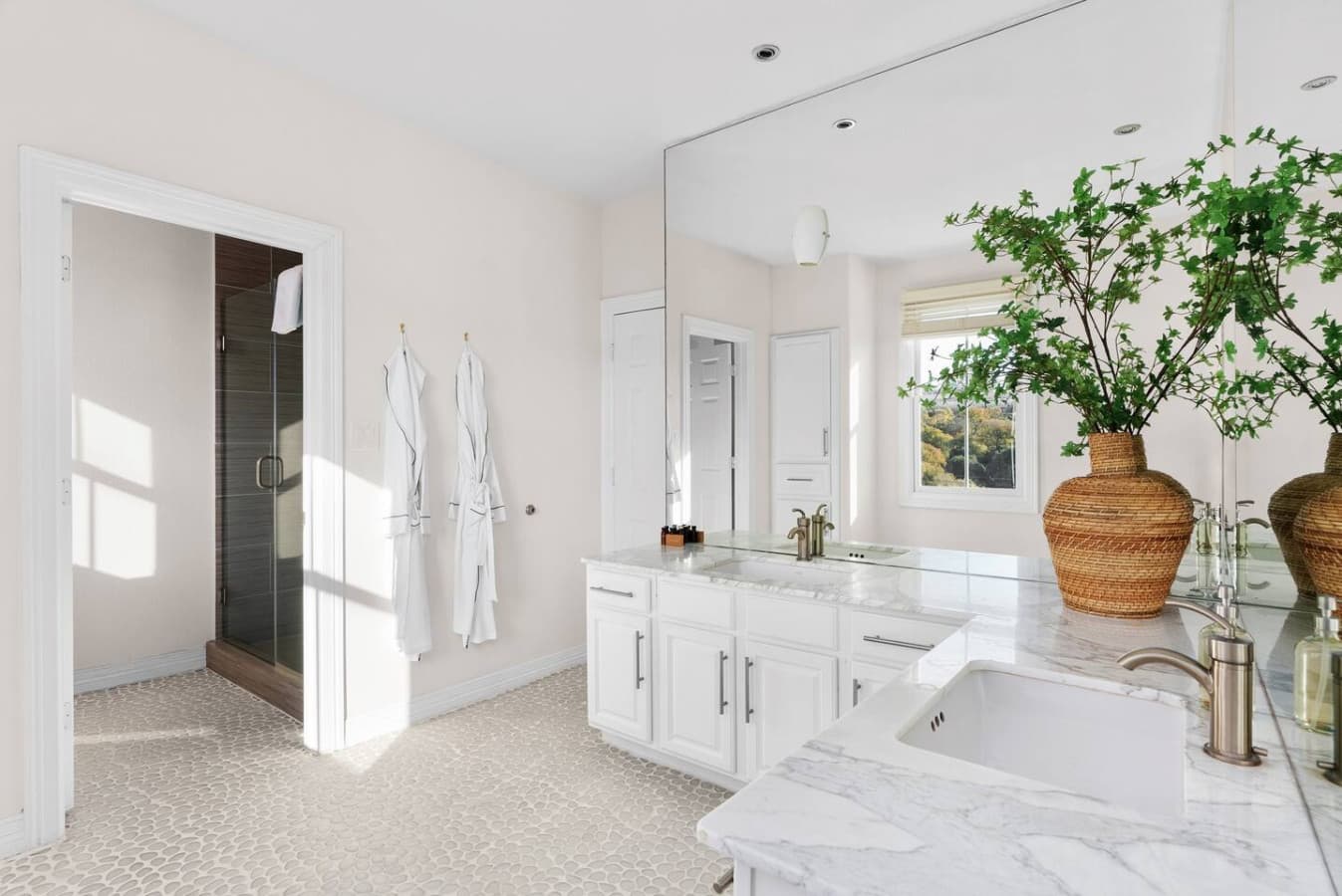 Master ensuite bathroom featuring double vanity sinks.