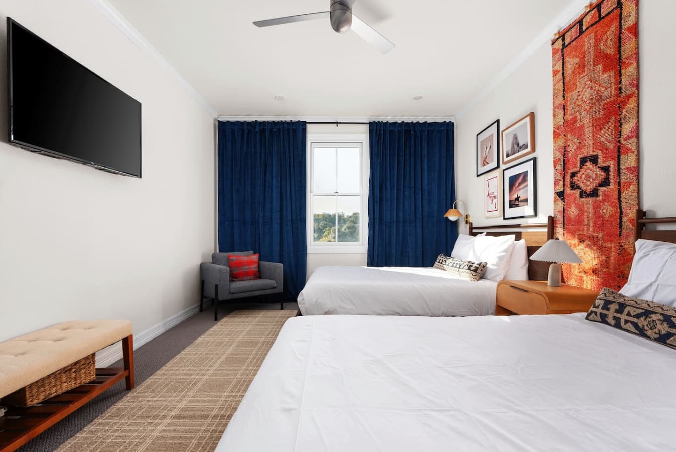 Third bedroom boasting stylish chic details with two queen beds outfitted with premium linens.