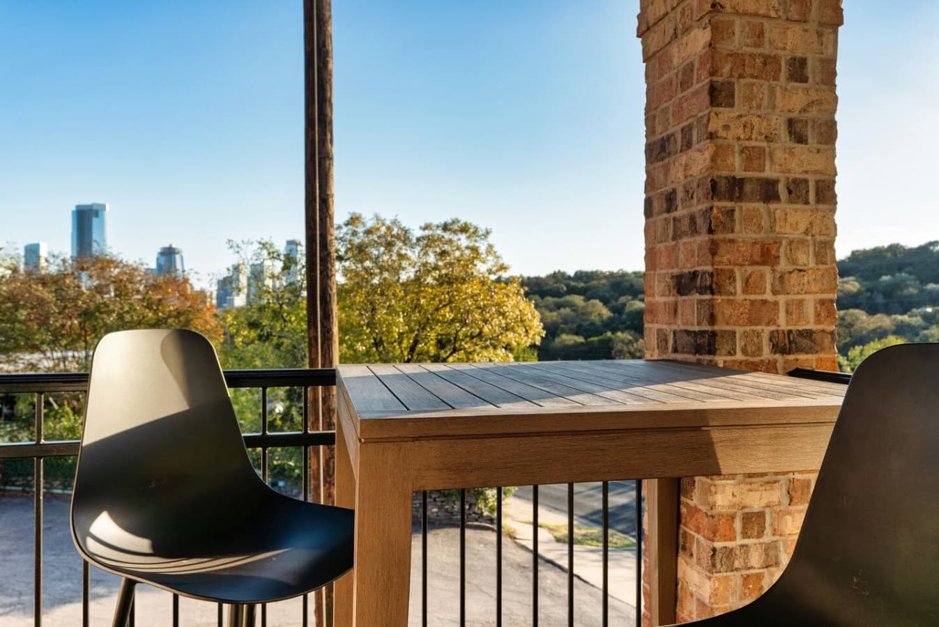 Outdoor space featuring chairs and city skyline views.